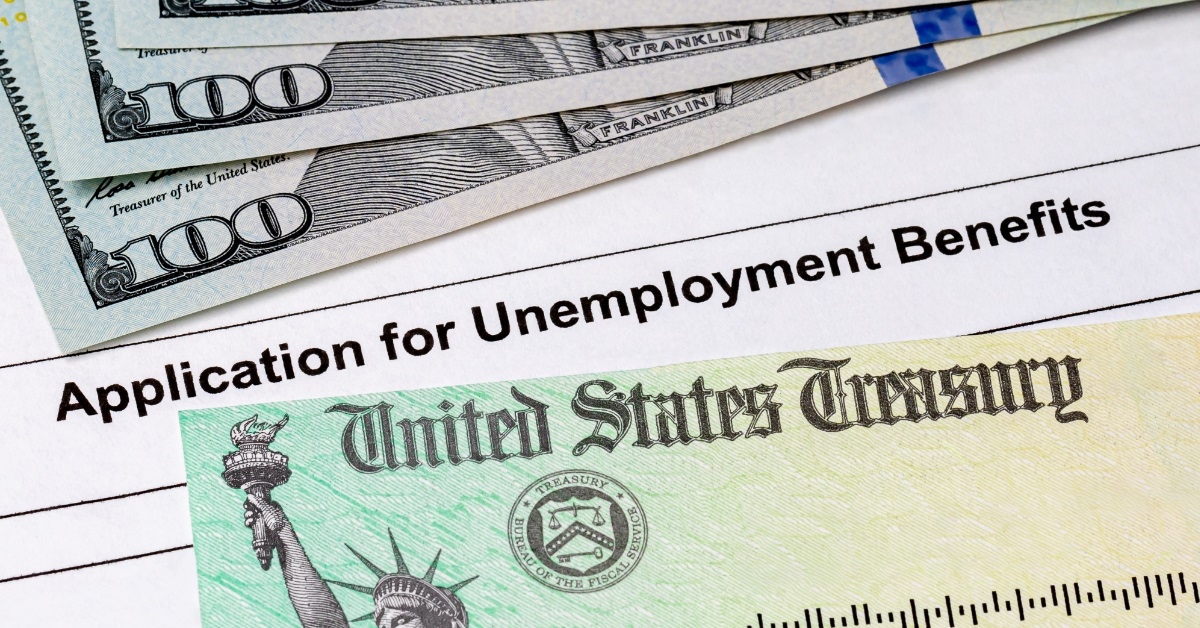 banknotes on unemployment benefits application form