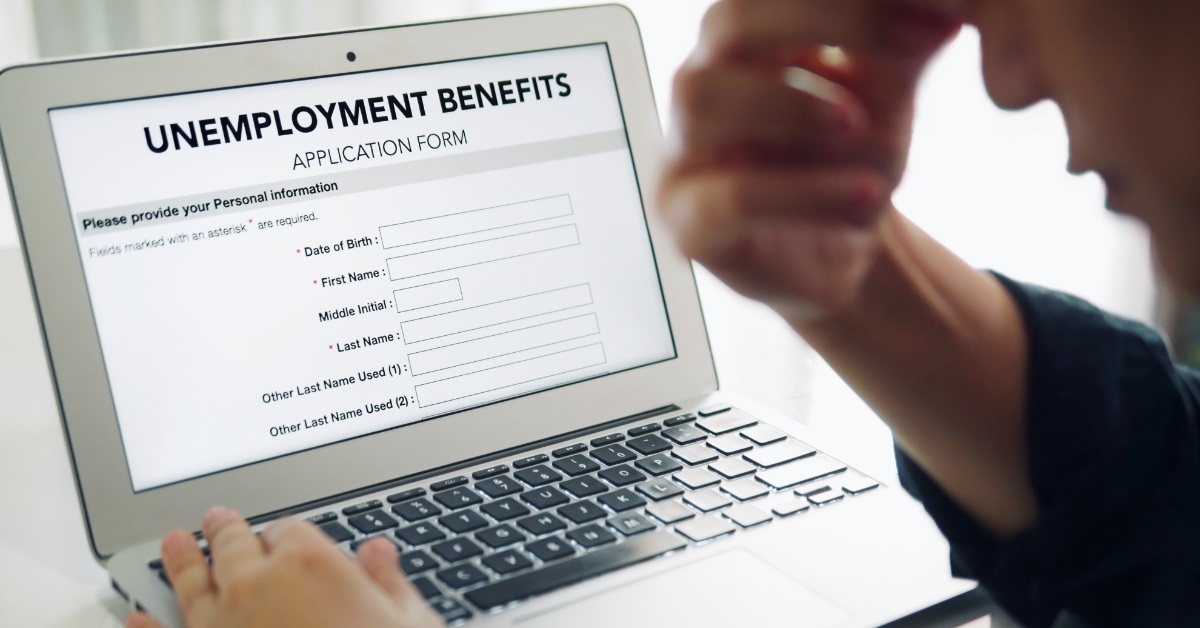 depressed man filling unemployment form online