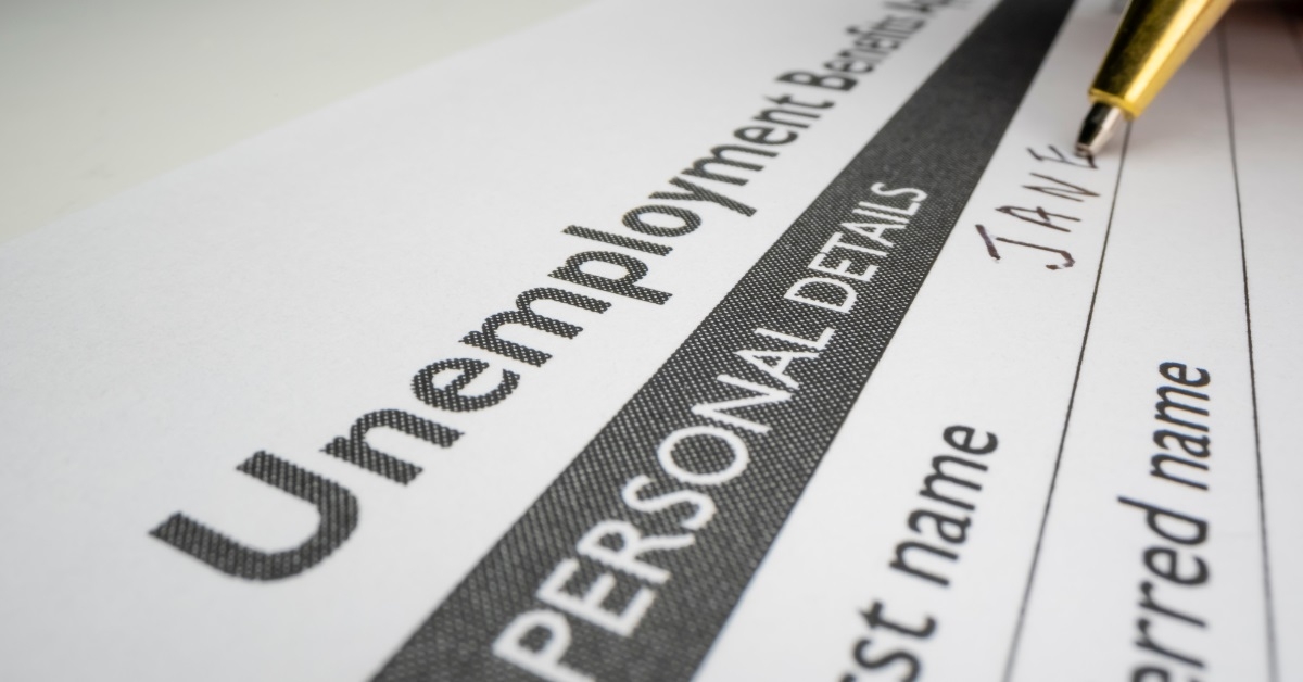 man filling unemployment benefits application form
