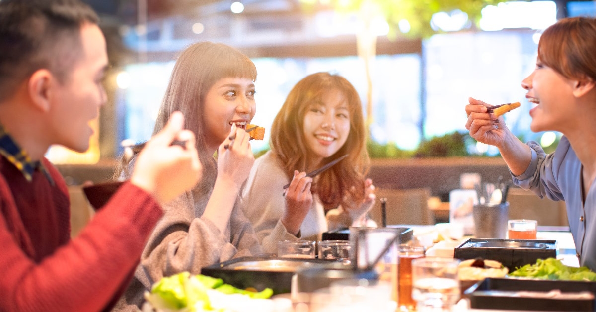 asian friends having lunch at restaurant