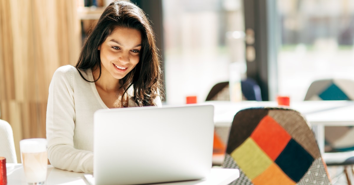 woman studying on laptop at cafe