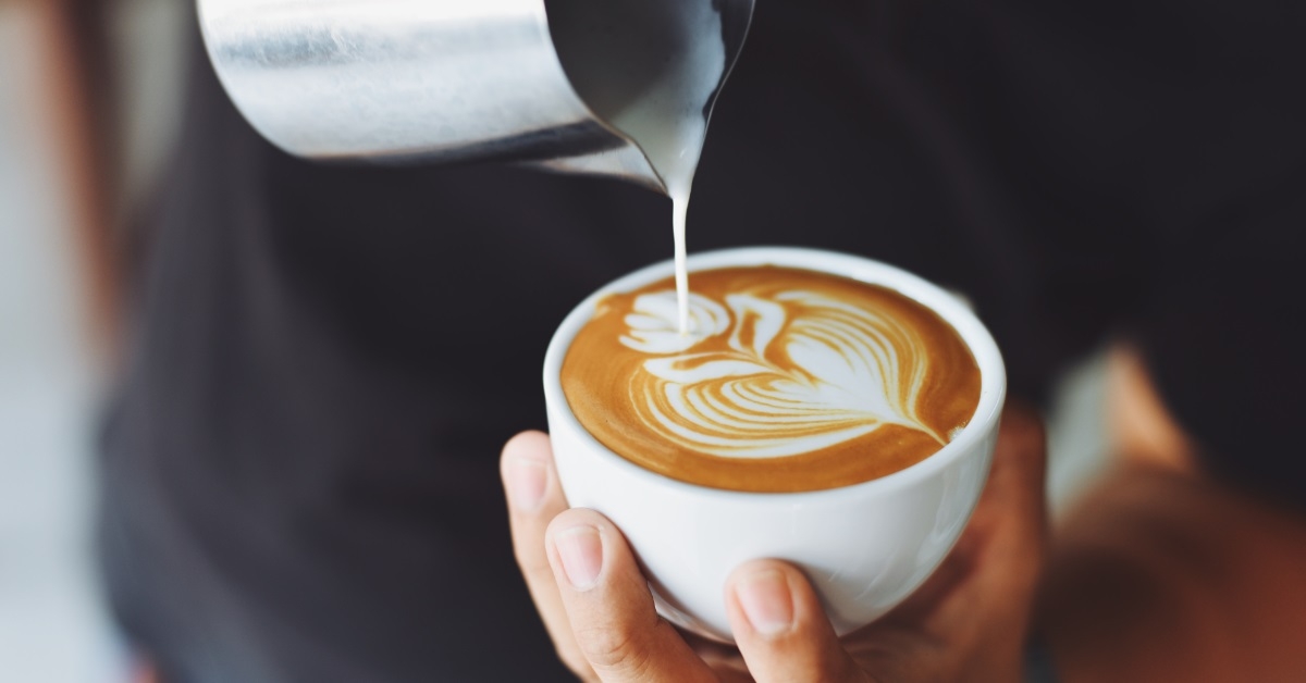 barista doing latte art at cafe