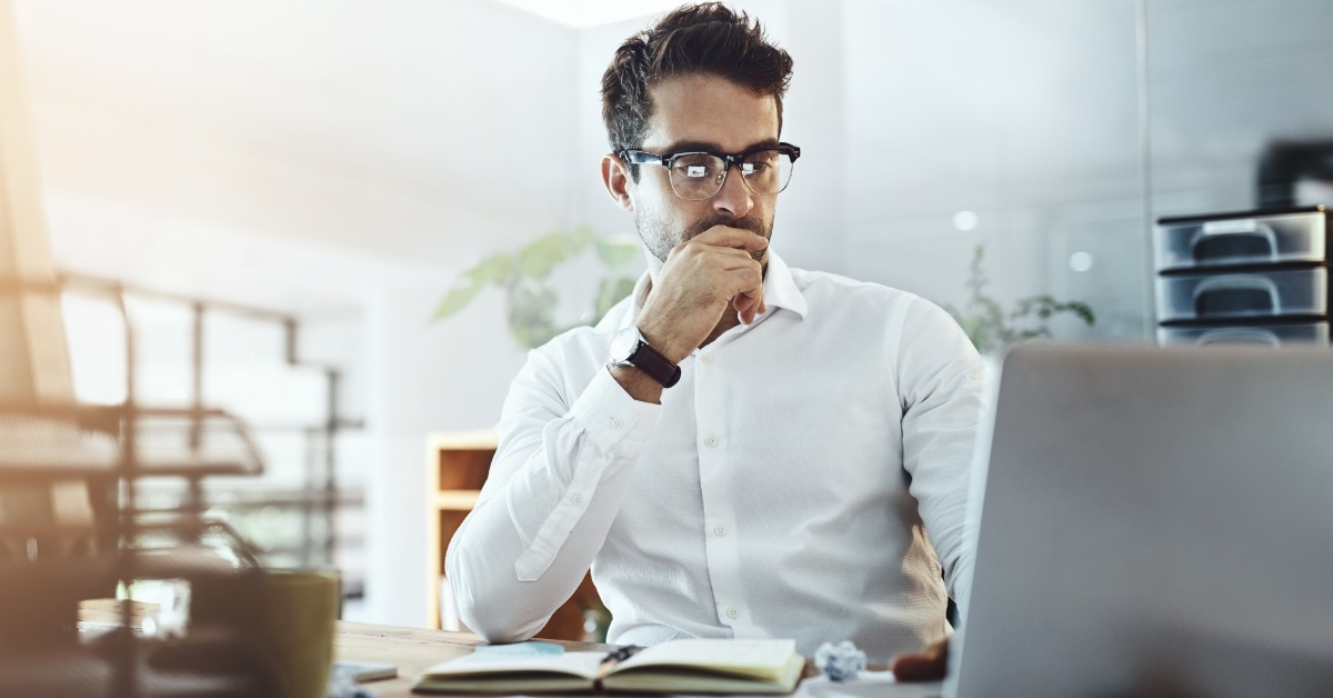 focused businessman using laptop at work