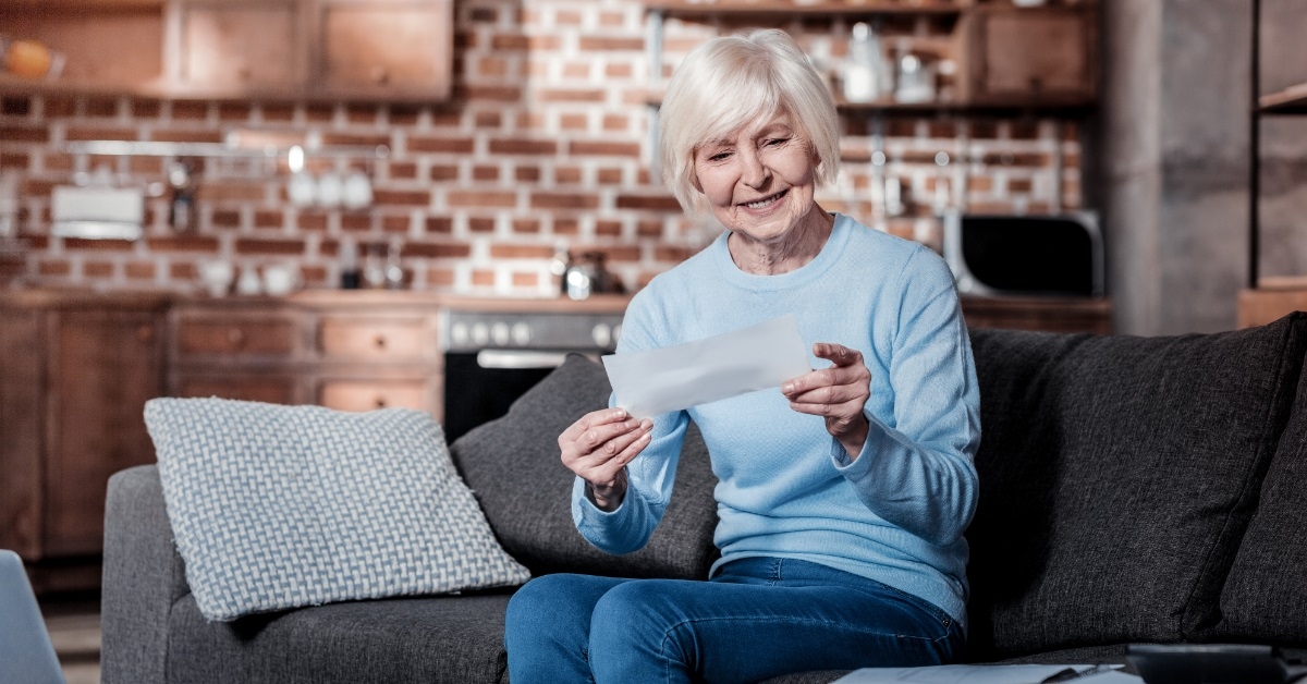senior woman happy about clearing debts