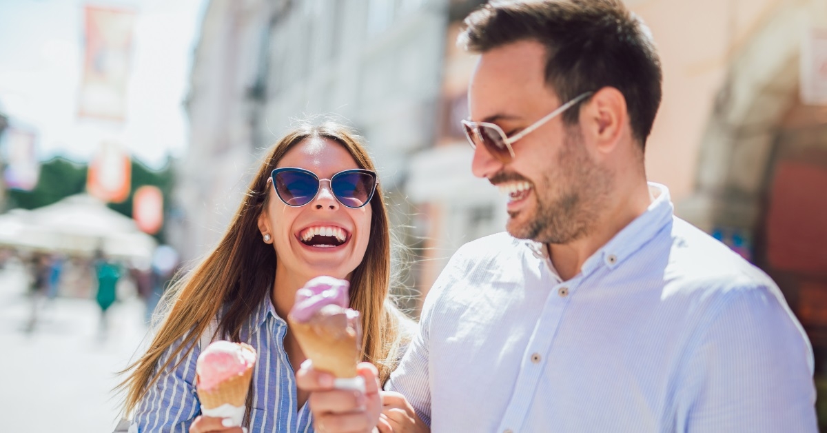 happy couple having icecream on date
