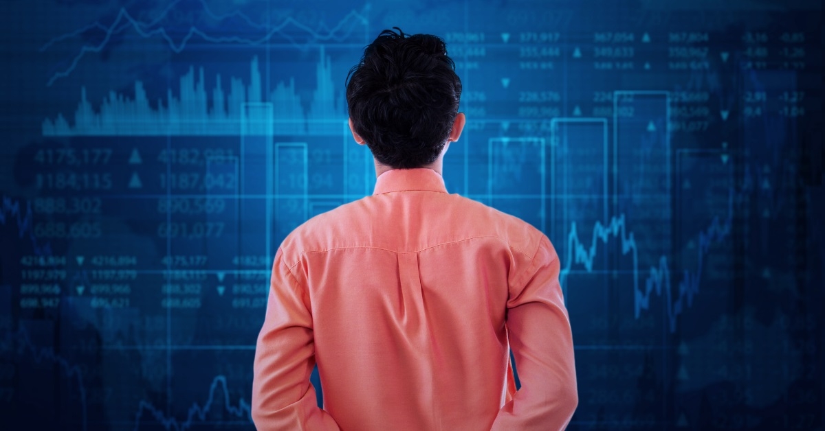 male broker observing stock market graph