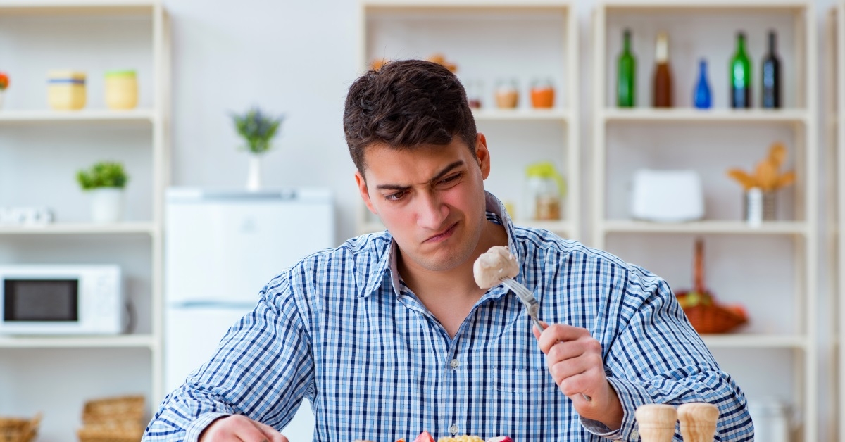 unhappy man having tasteless food
