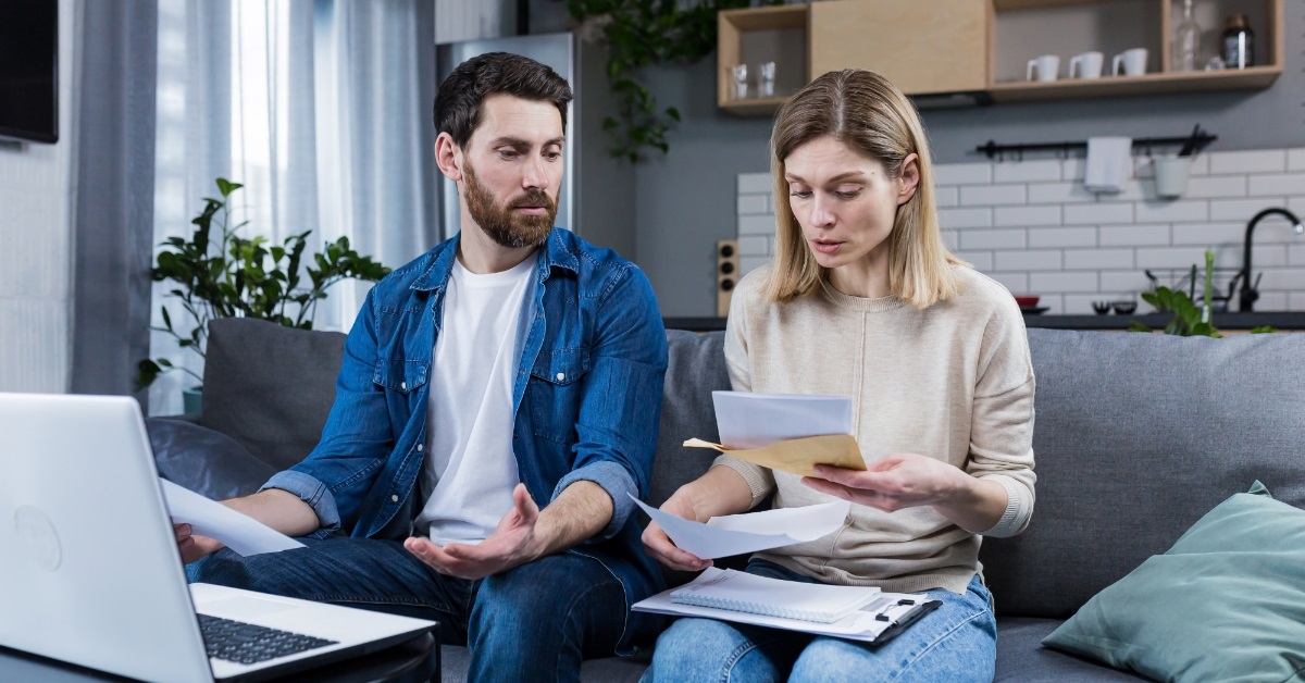 young couple riewing bills at home