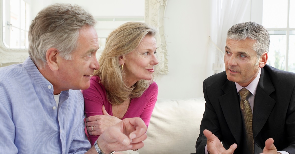 senior couple consulting male finance advisor
