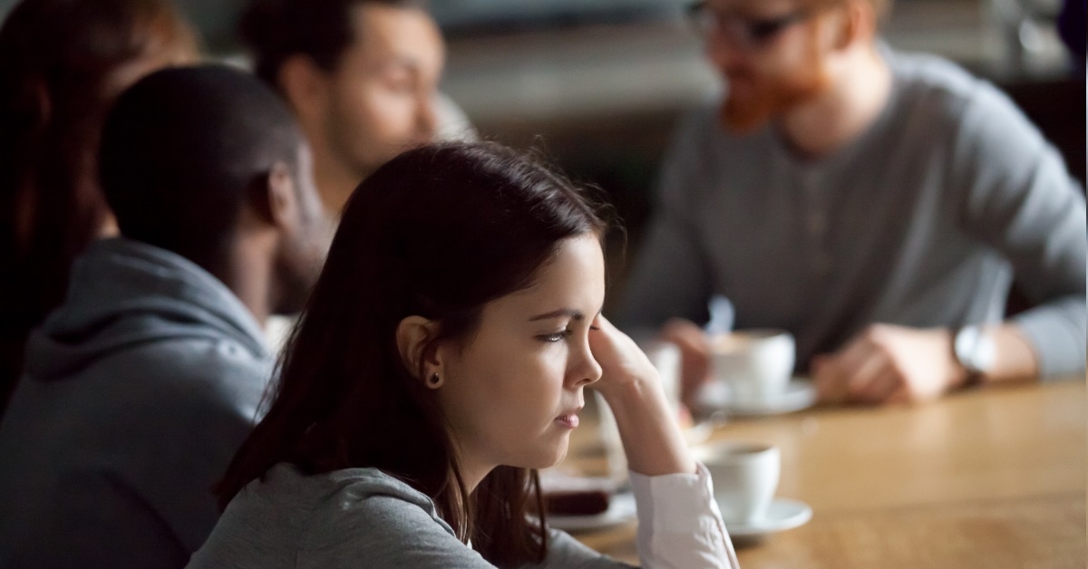 upset girl sitting at cafe table
