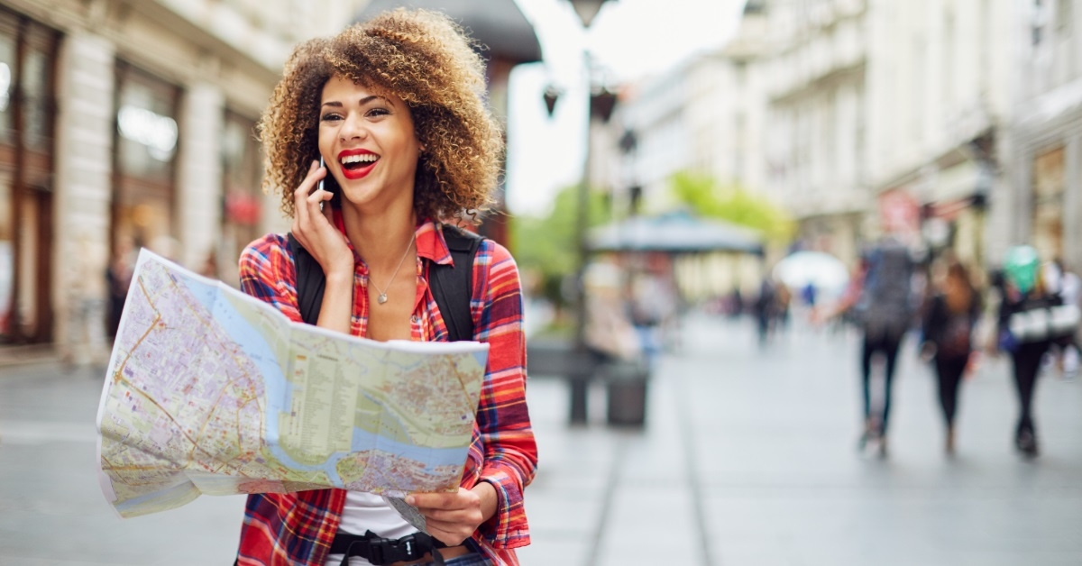 female tourist walking outdoor with map