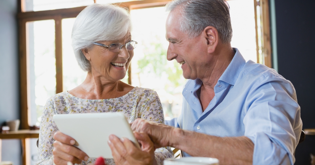 senior couple using digital tablet