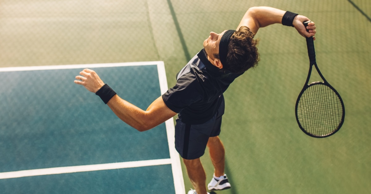 male tennis player playing match