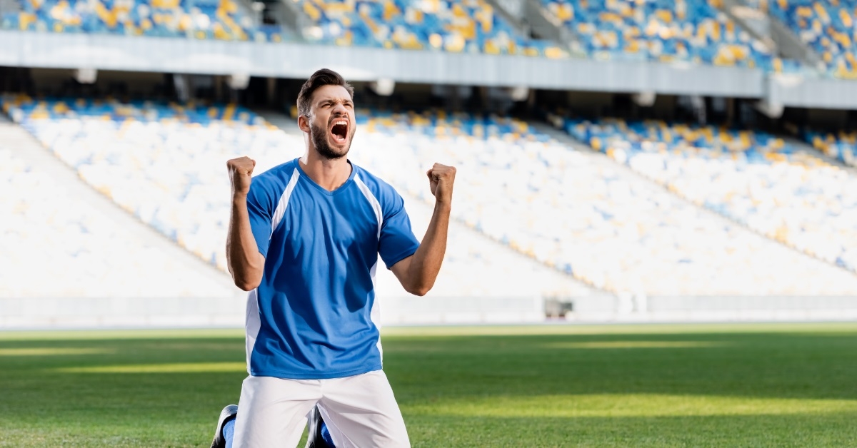 soccer player celebrating after making goal