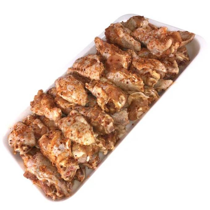 plate of uncooked kirkland signature chicken wings with garlic pepper seasoning
