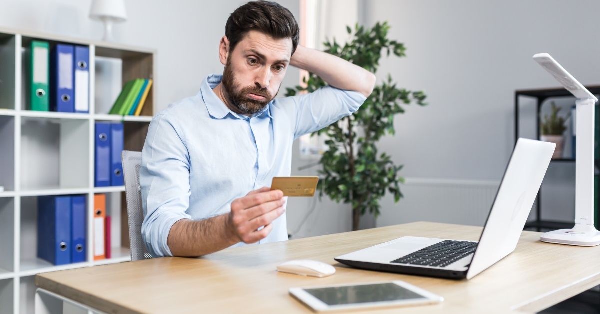 frustrated man holding card