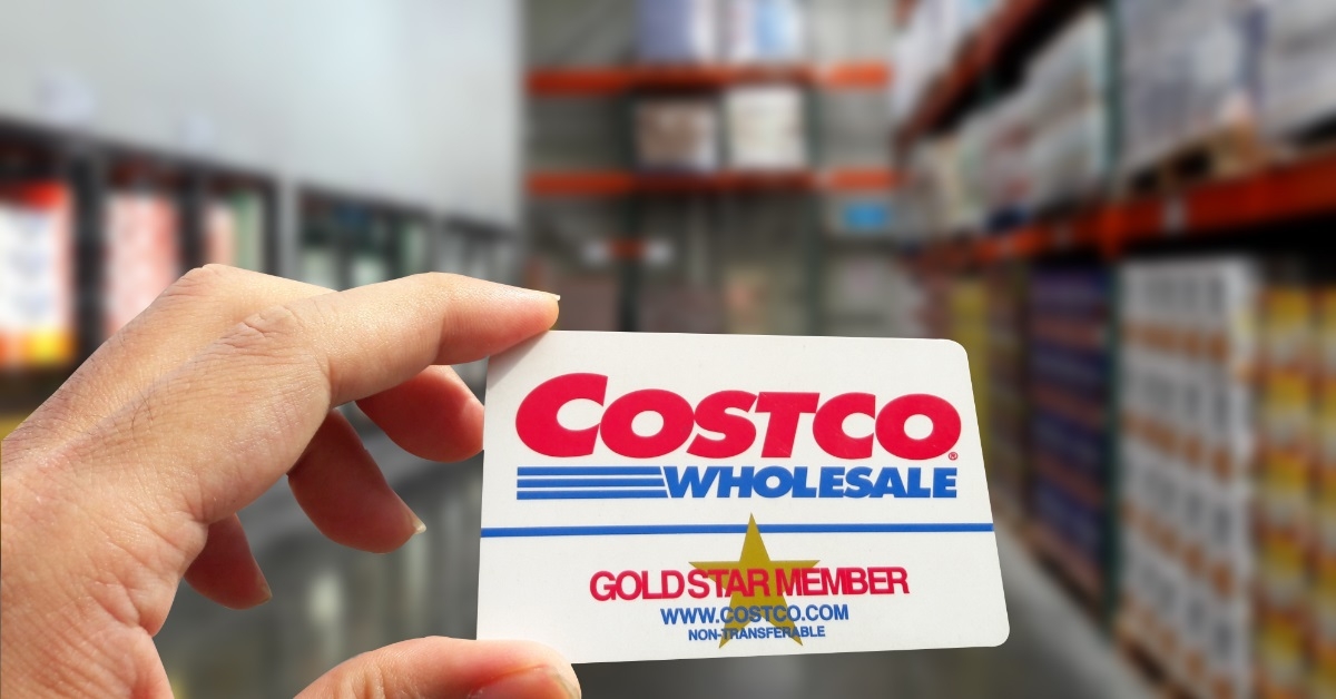 man holding costco gold membership card