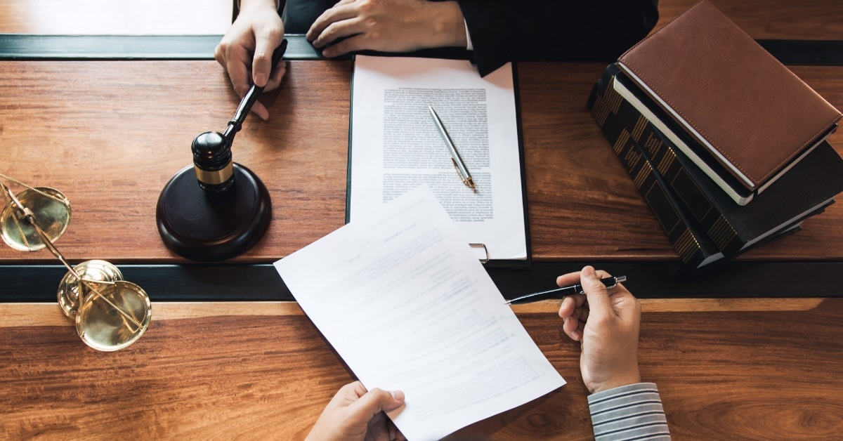 client discussing contract with lawyer