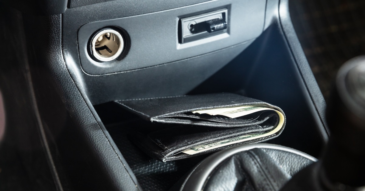 black wallet besides car gear
