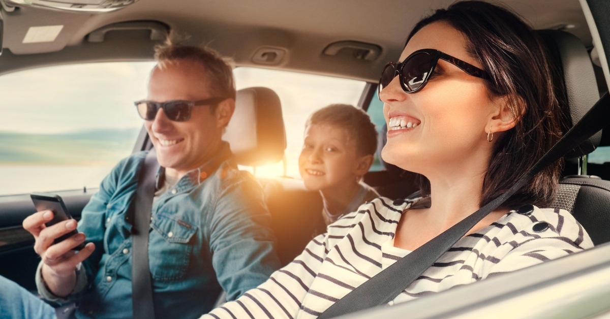 happy family in car on trip
