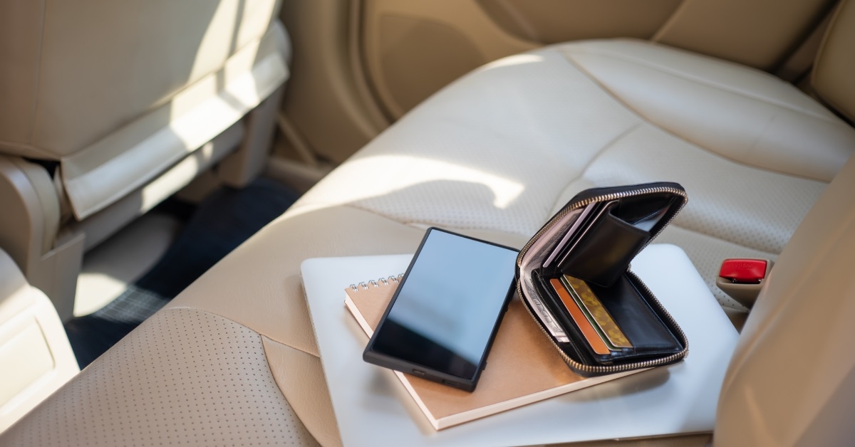 wallet mobile laptop on car backseat