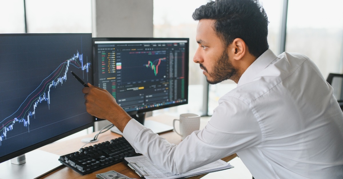male broker analysing crypto charts
