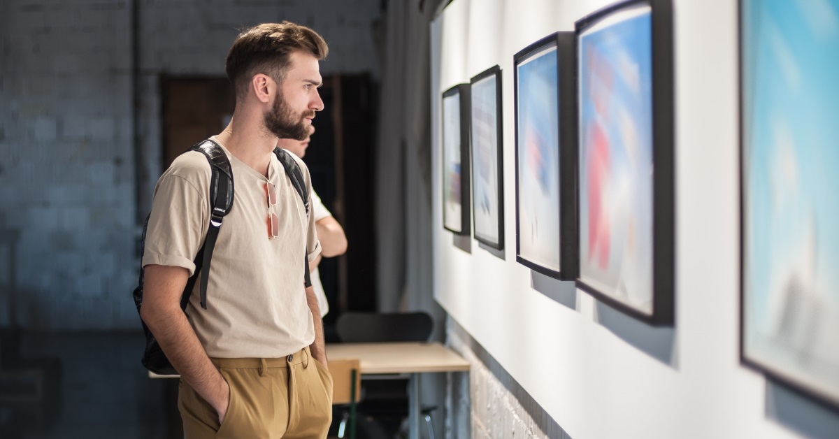 man contemplating art in modern gallery