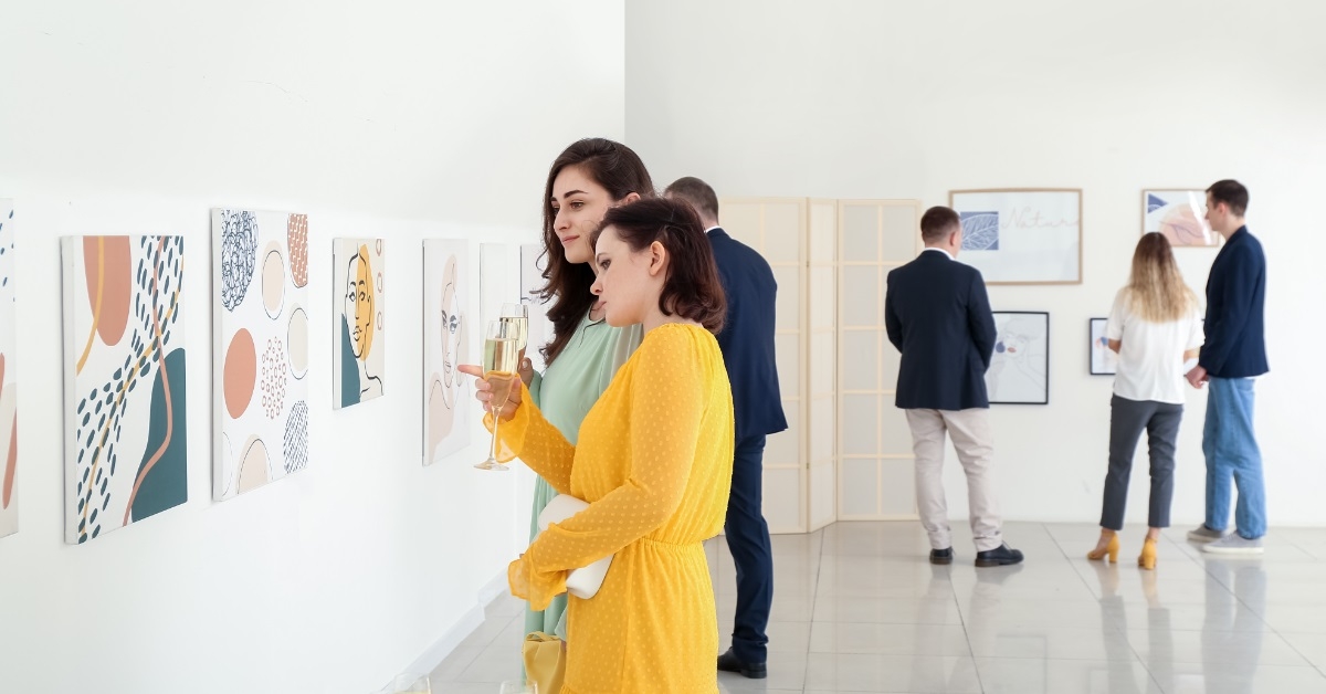 attractive women talking at art gallery