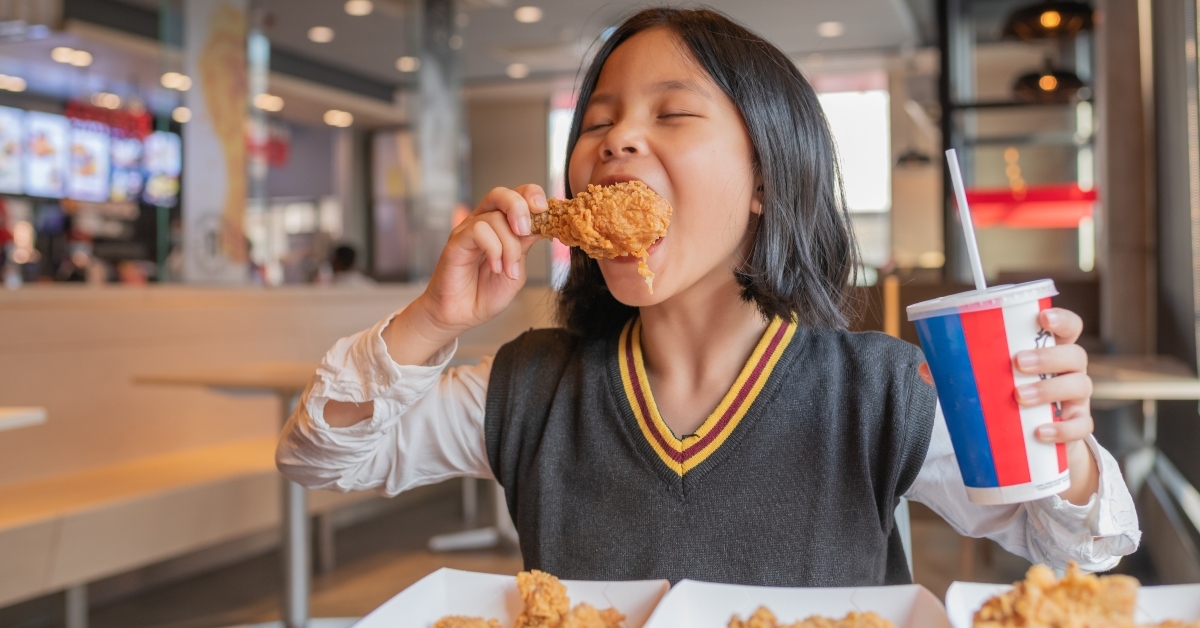 asian girl eating fried chicken