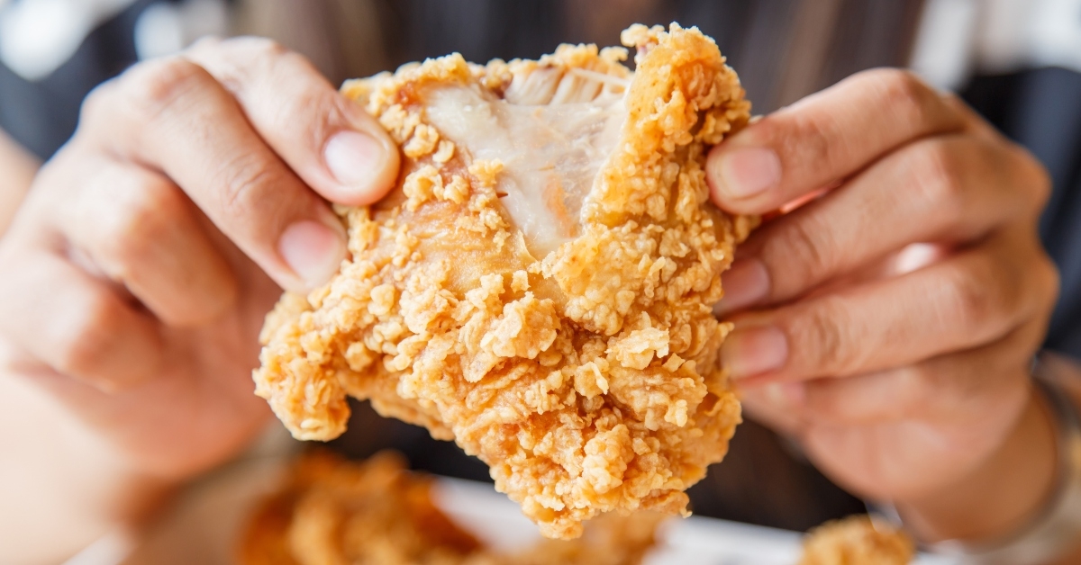 hand holding fried chicken
