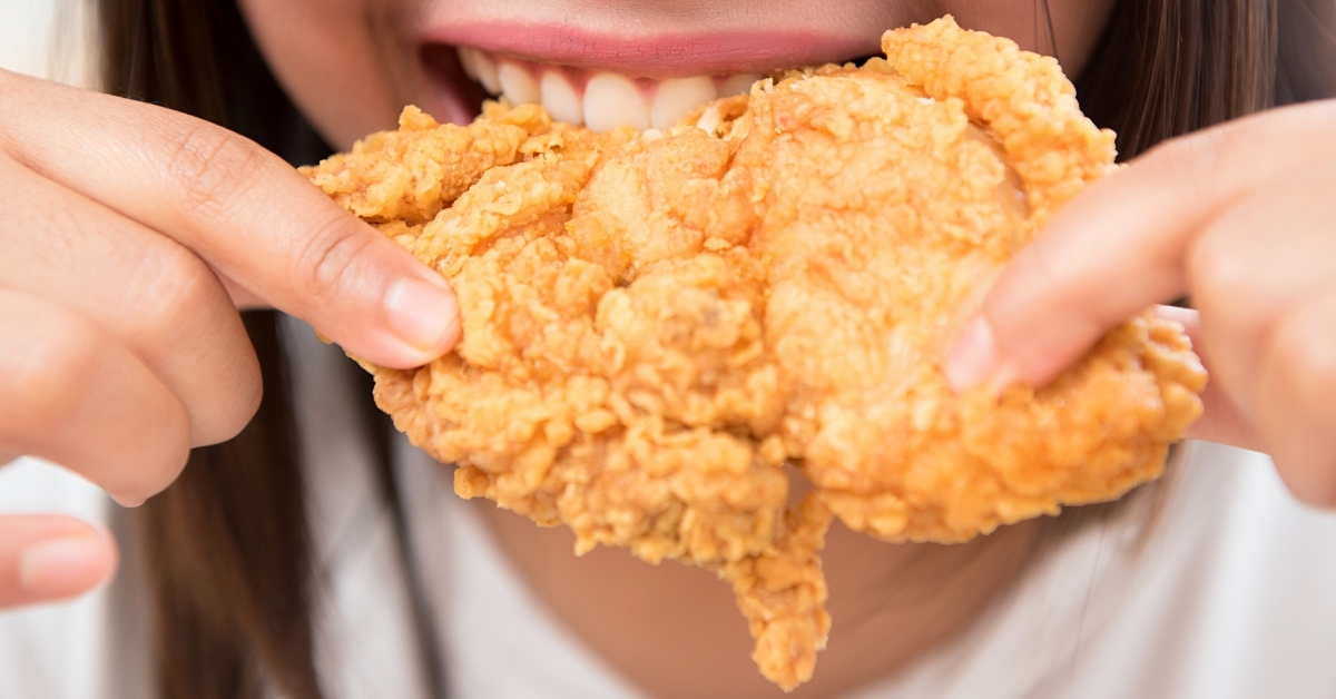 woman eating deep fried chicken