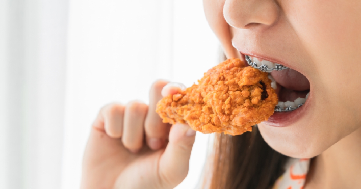braces holding fried chicken