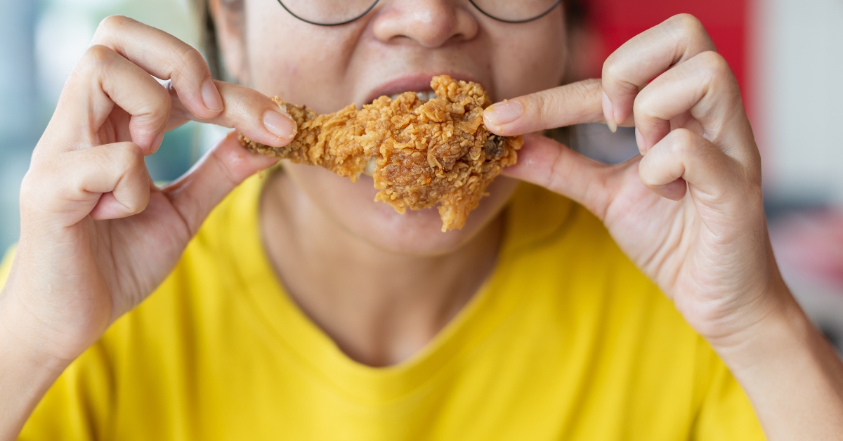 holding and eating fries chicken