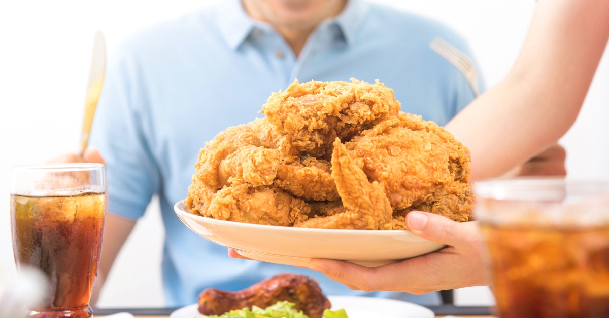 waiter putting fried chicken