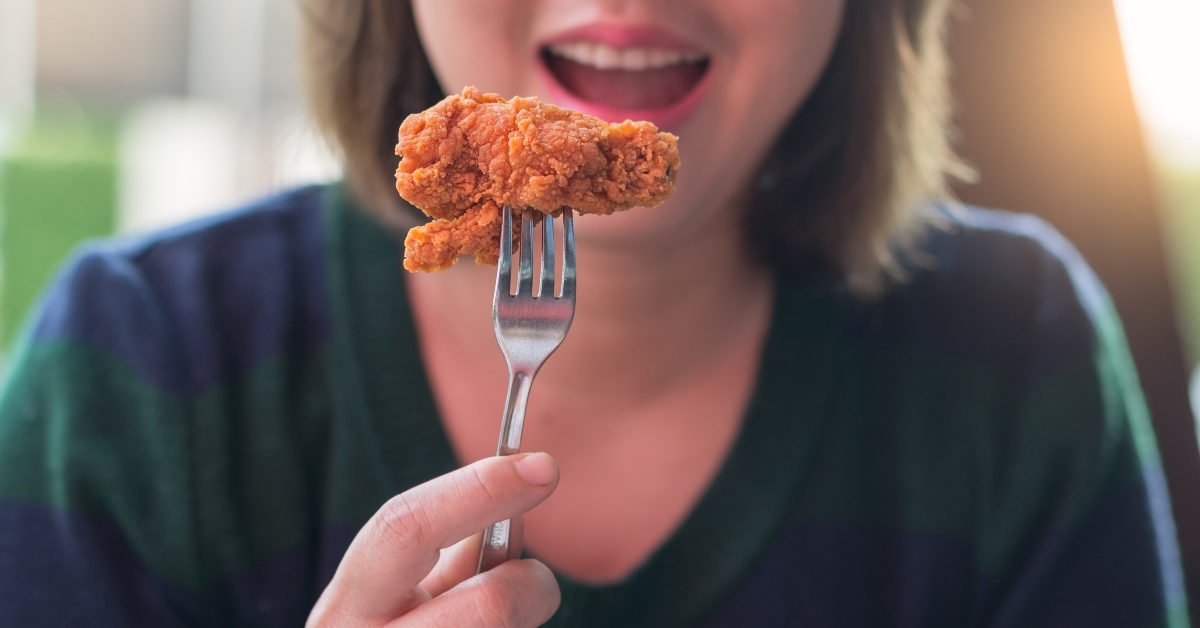 woman eating fried chicken
