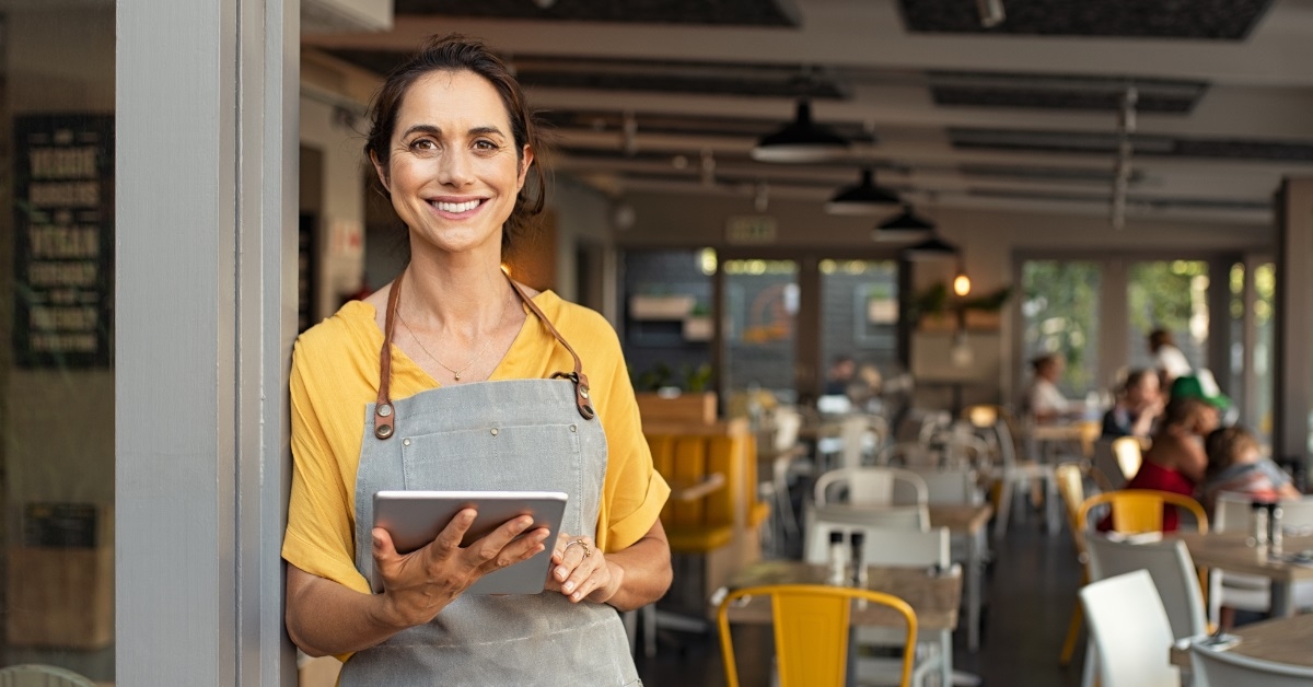 female cafe owner posing at restaurant