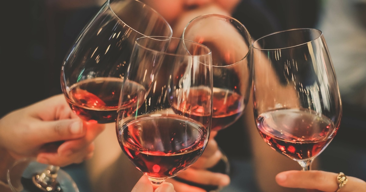 friends toasting red wine glasses