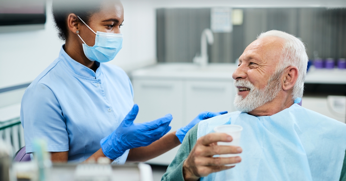happy senior man and dentist