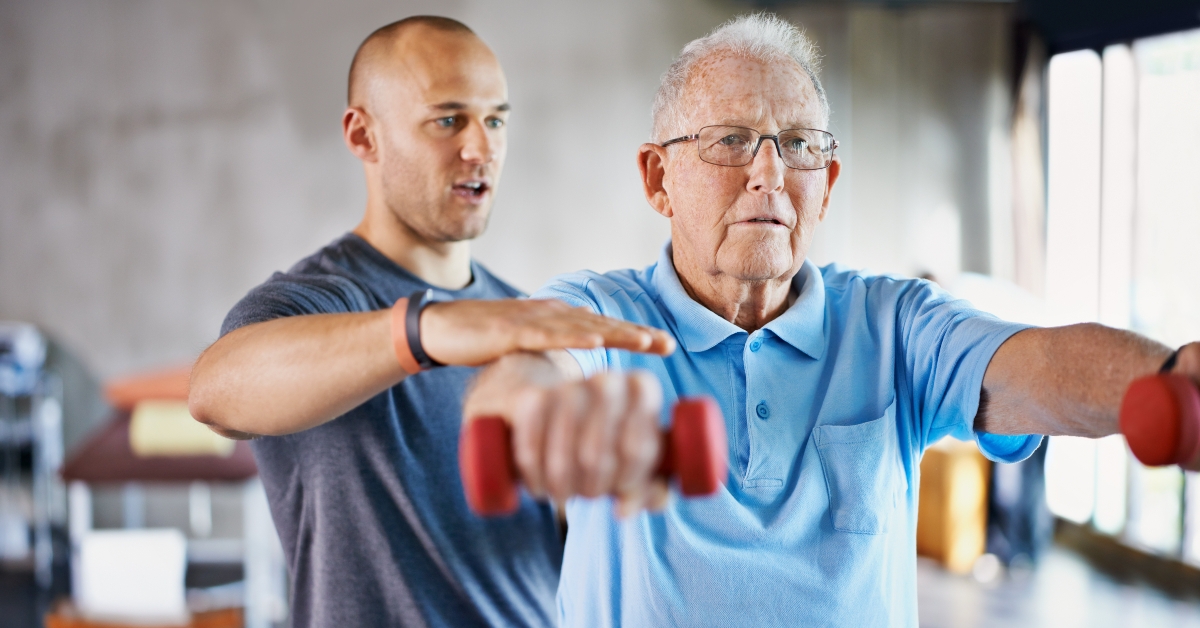 physiotherapist helping a senior man