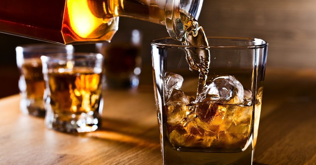 whiskey poured on ice in glass