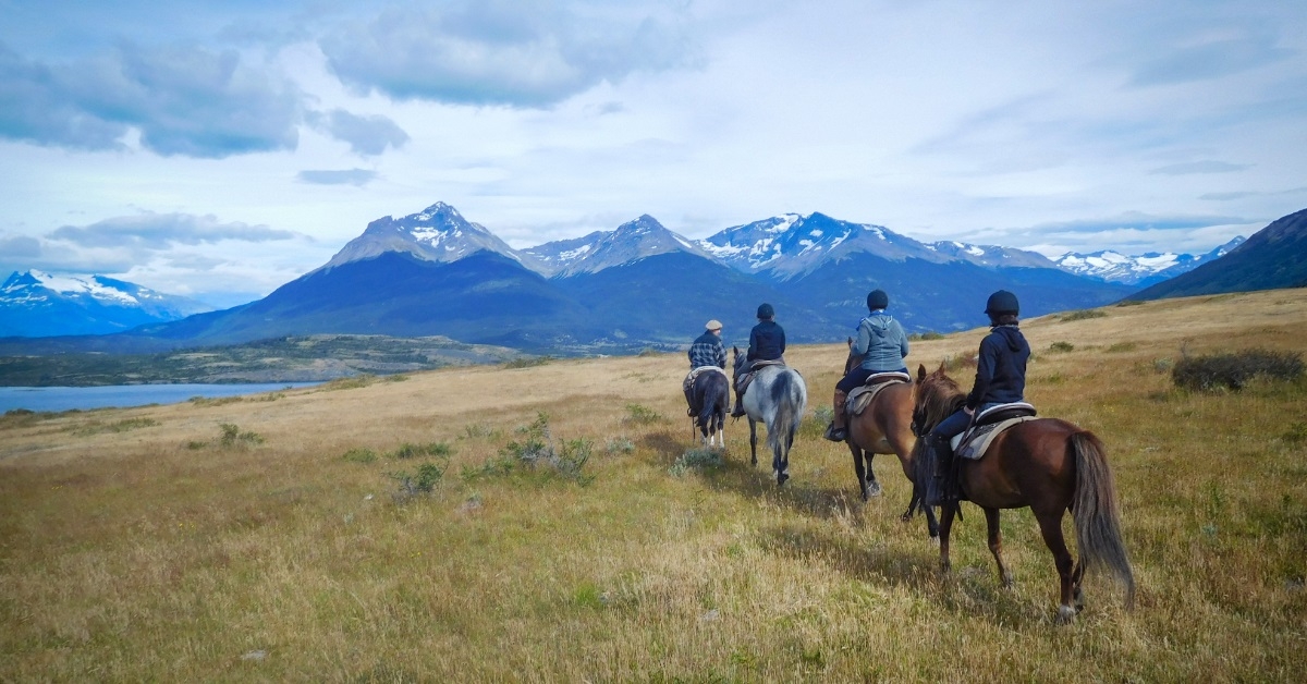people horse riding in patagonia