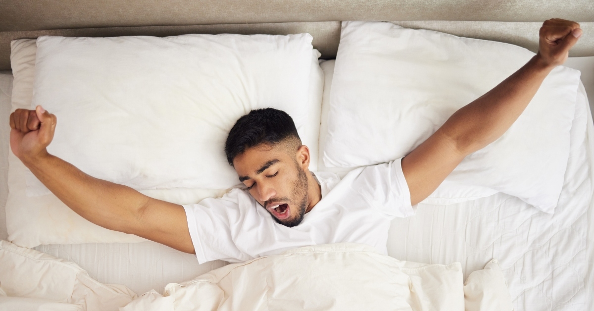 man waking up in a bed