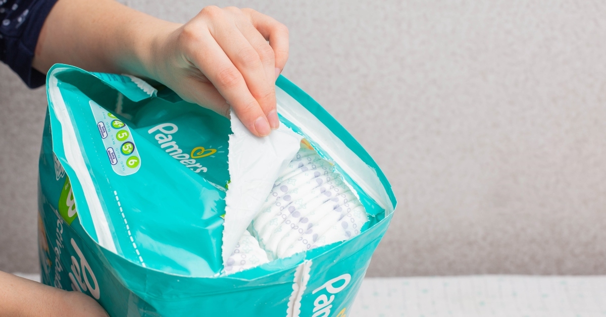 woman opens a pack of diapers