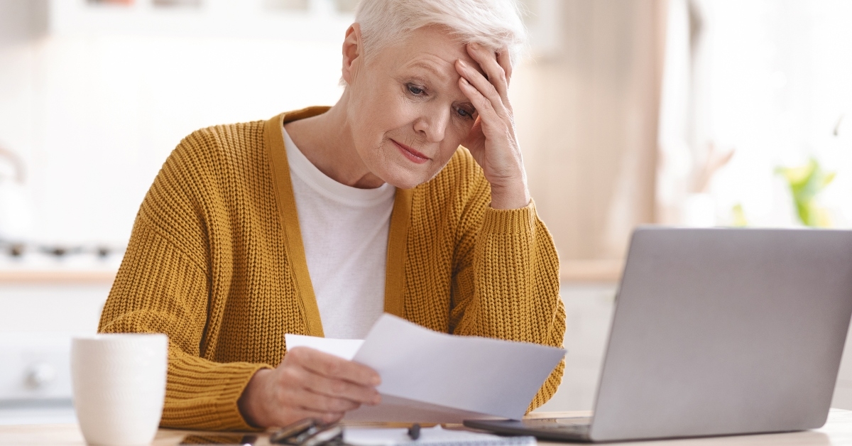 senior lady reading bills