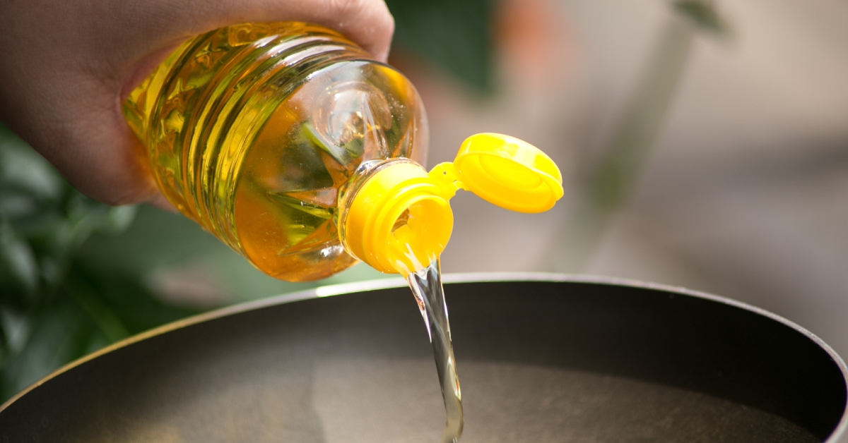 pouring cooking oil into pan
