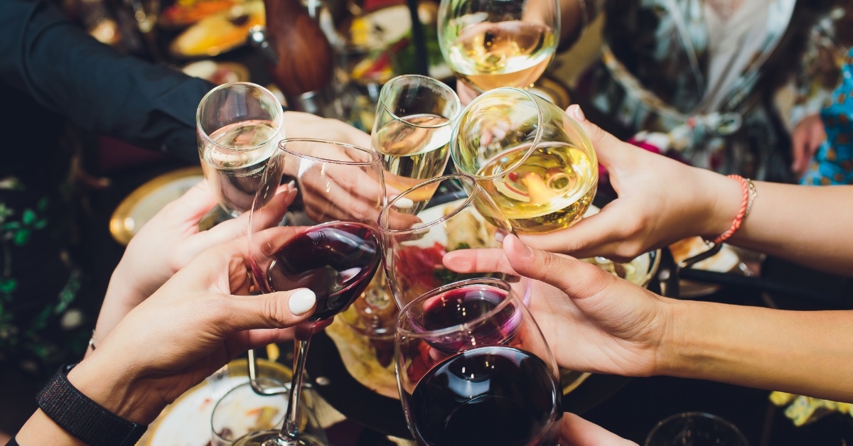 hands toasting champagne glasses at party