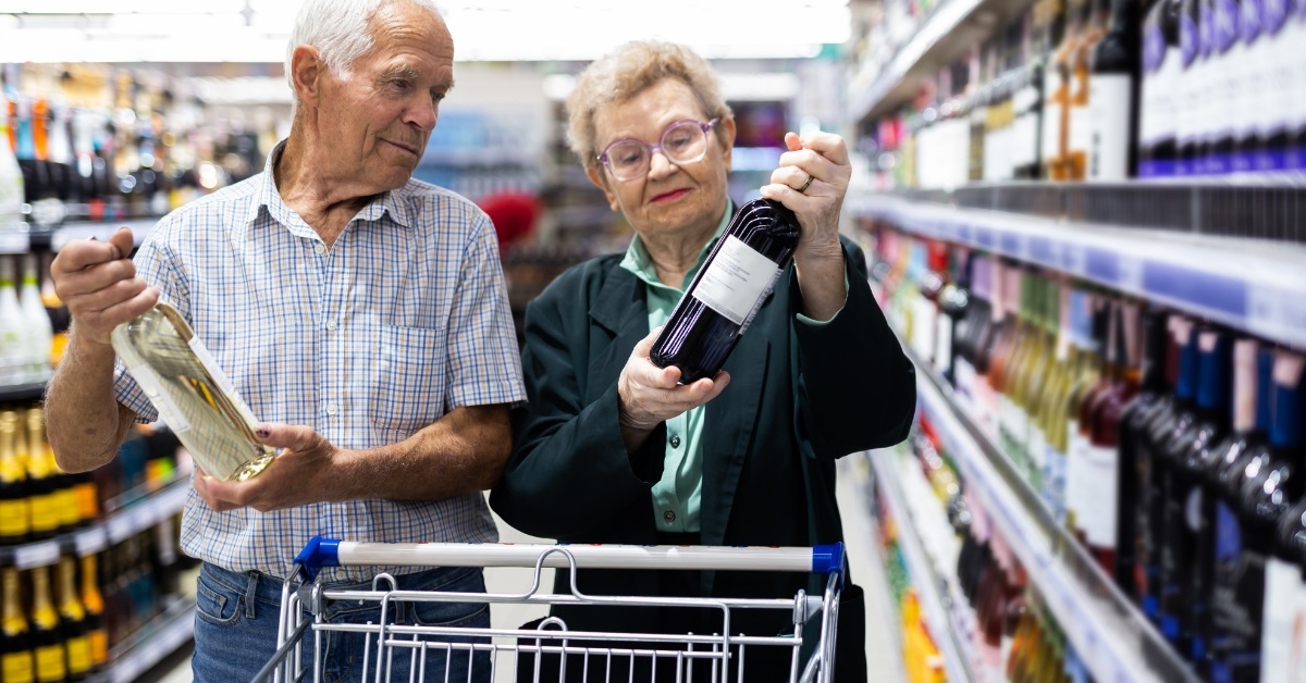 senior couple buying liquor at supermarket