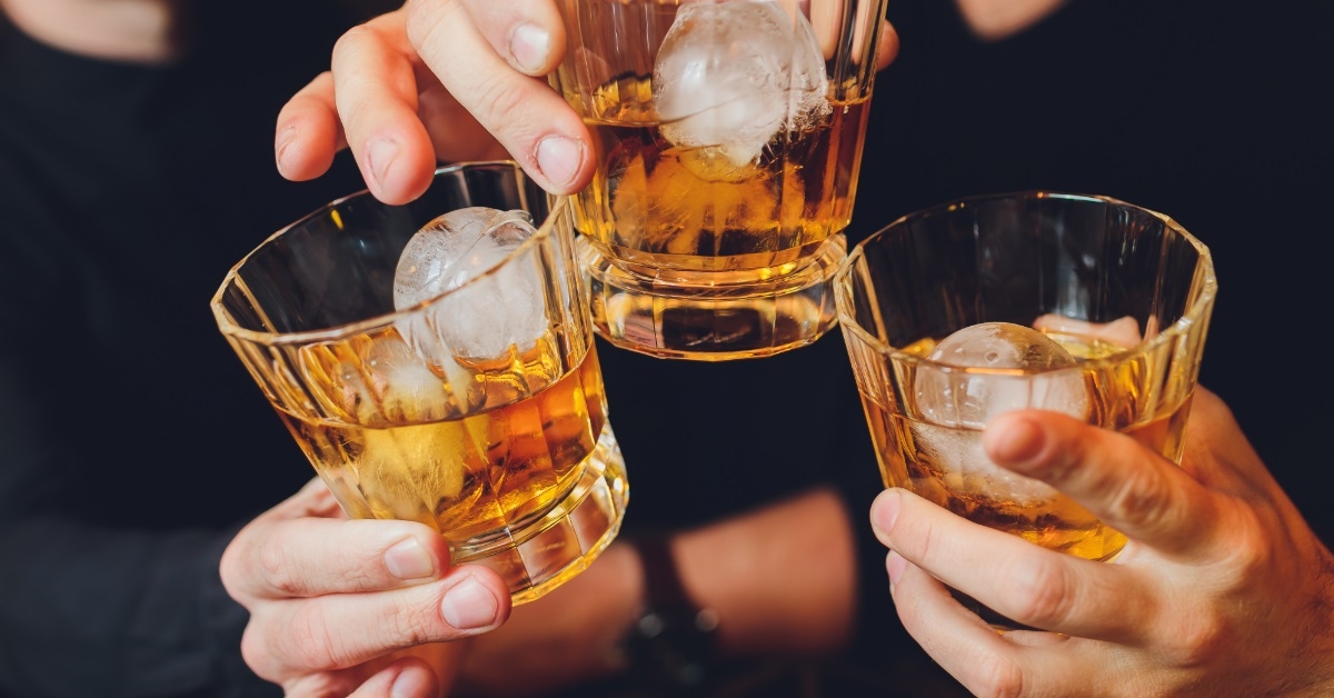 friends clinking alcohol glasses at party