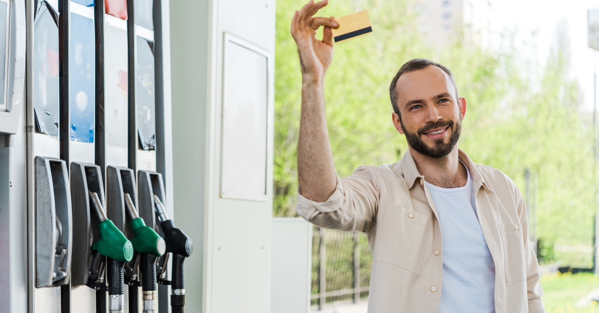 holding credit card and smiling