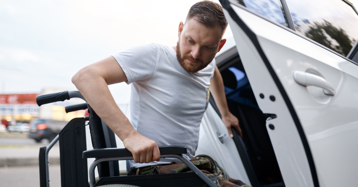 veteran shifting on wheelchair from car